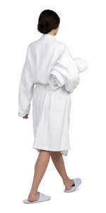 woman in a soft white bathrobe walking