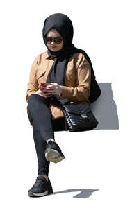cut out muslim woman sitting and texting