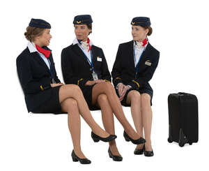 three cut out flight attendants sitting and talking