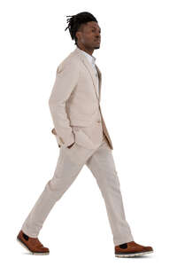 man in a white suit walking hand in his pockets