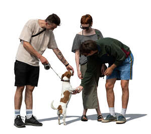 group of cut out people standing and playing with a dog
