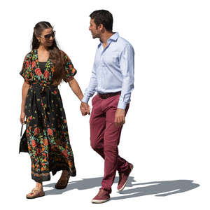 dark haired couple walking hand in hand in summer outside