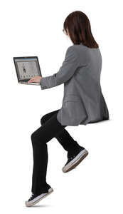 woman working with a computer sitting at a counter table