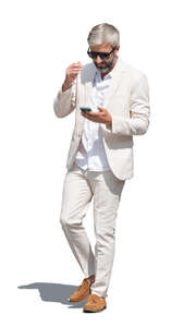cut out man in a white suit walking