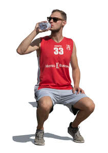 cut out sportsman sitting and drinking water