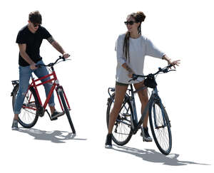 two cut out backlit people with bikes standing ready to start riding 
