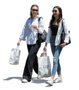 two happy women with shopping bags walking