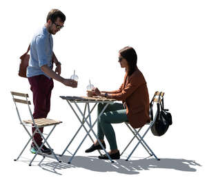 backlit scene of a casual coffeeshop with two people