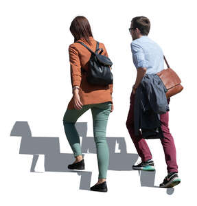 man and woman walking up the stairs outdoors