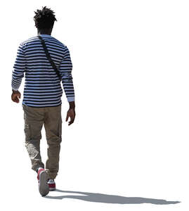 cut out backlit black man in a striped shirt walking