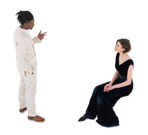 top angle view of a man in a white suit talking to a woman in black sitting