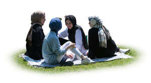 cut out group of muslim girls having a picnic on the grass