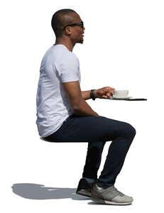 black man sitting in a cafe in summer