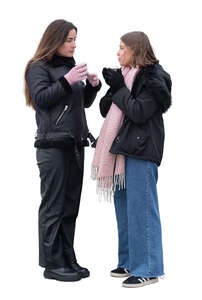 two cut out young women standing and drinking hot drinks