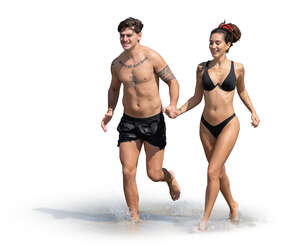 couple running happily along the beach