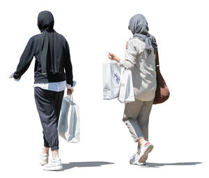 two muslim women with shopping bags walking 