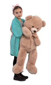 little girl with a big teddy bear standing