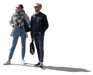 backlit man and woman standing and facing the same direction