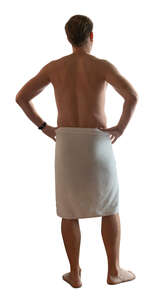 man in a sauna towel standing and looking out of the window
