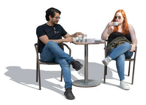 two people sitting outside in a cofeeshop