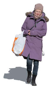 woman with a big bag of groceries walking in winter