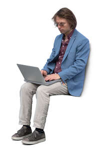 young man with a laptop sitting and working