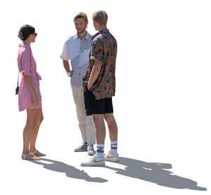 backlit group of three young people in summer standing and talking