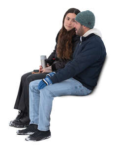 two cut out people sitting outside in winter and drinking hot tea