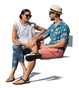 man and woman sitting outside in summer and talking