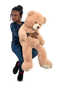 little black girl with a big teddy bear sitting