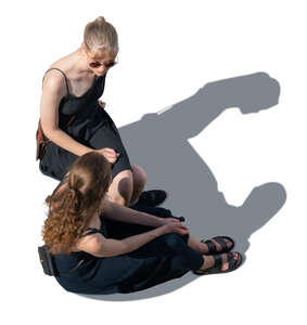 two women in black summer dresses sitting seen from above