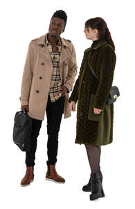 two people wearing light overcoats standing