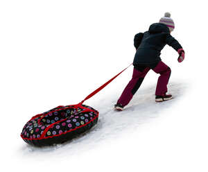 cut out little girl climbing up a snowy hill with her sledge