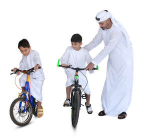 arab man with two kids riding bikes