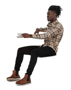 black man sitting a cafe and drinking coffee