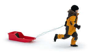 little boy with a sledge running in the snow