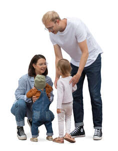 family with two little kids standing in the street