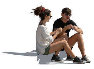man and woman sitting on the sidewalk and eating ice cream