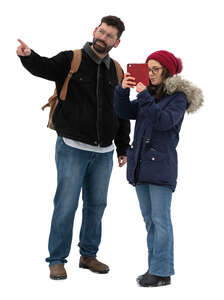 man pointing and woman taking a picture