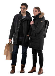 man and woman standing in winter and looking at shop windows