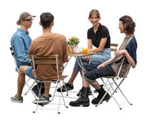 group of four young people sitting in a restaurant and talking