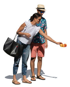 man and woman buying apples at the market