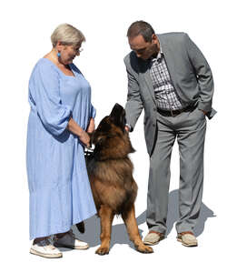 man and woman with a german shepard standing