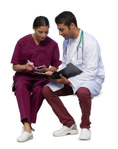 two medical workers sitting and talking