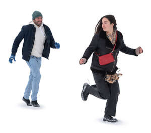 man and woman running in the snow