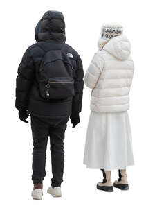 man and woman dressed in black and white winter jackets standing