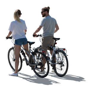 cut out backlit man and woman on bikes stopping to talk 