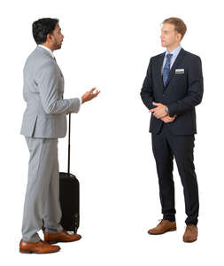 cut out businessman talking to a hotel receptionist