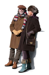 older couple standing outside on a balcony in winter