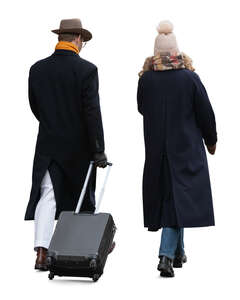 two people walking with a suitcase in winter